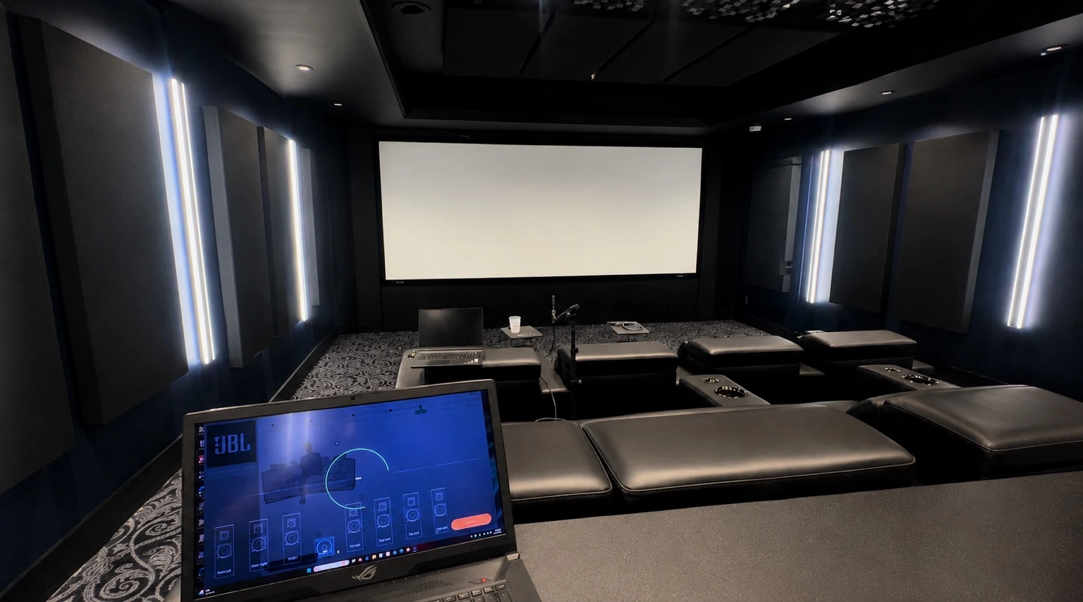 Private home theater with projection screen and calibration laptop